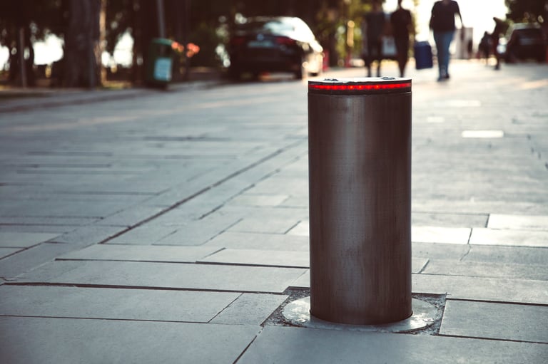 Illuminated retractable automatic traffic bollard protects pedestrian zone