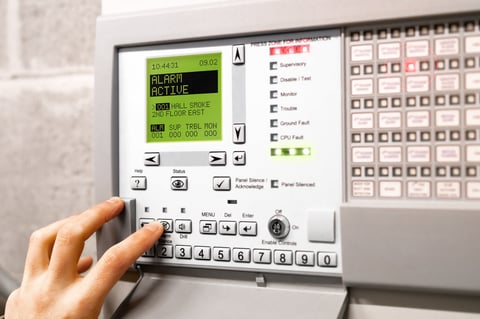 Alarm system control panel with house protection icons and flickering red lights