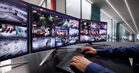 Computer Operator Monitoring CCTV Footage For Advanced Security System