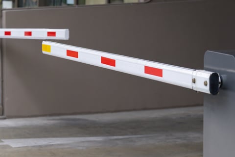 Modern barrier gate with safety stripes and steel housing